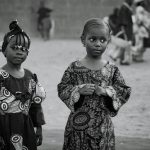 Two young girls in traditional attire in Minna, Nigeria, during a cultural celebration.